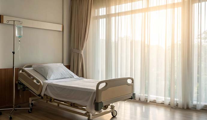 A clean hospital patient room with clean drapery