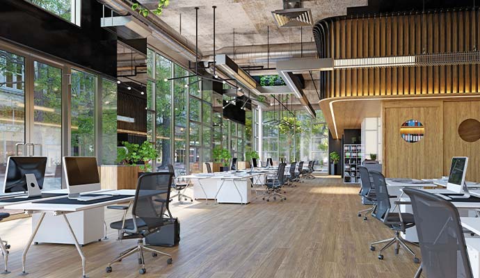 A clean open-plan corporate office interior with computer workstations