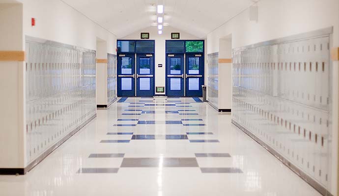 A long, clean school hallway with shiny tile floor