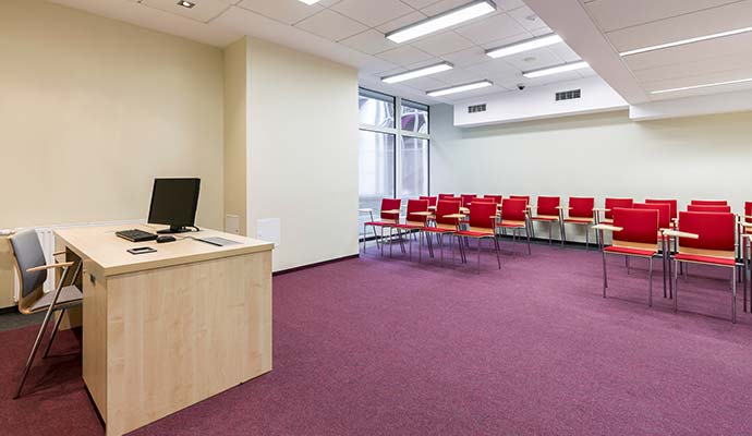 A modern classroom featuring purple carpet flooring