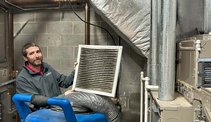 A professional replacing HVAC filter