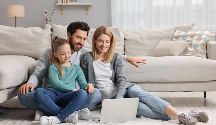 Family on living room with a laptop