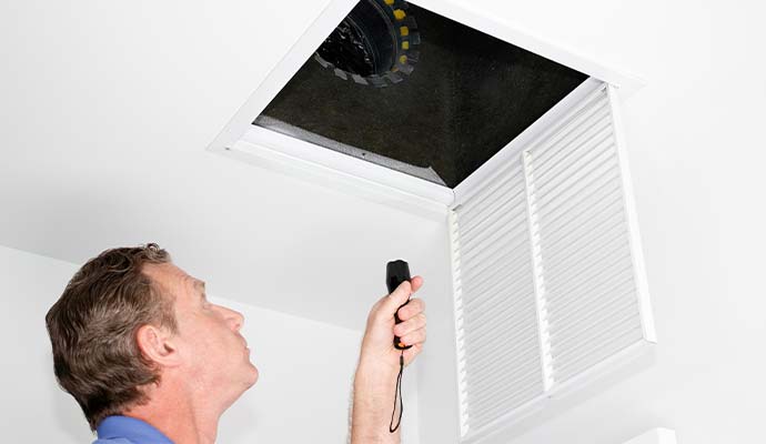 Professional air duct inspection service with flashlight