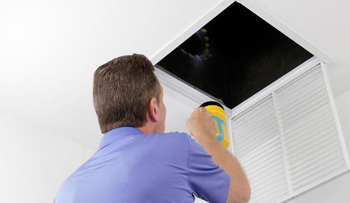 Professional air duct inspection service with flashlight