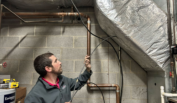 Technician cleaning office hvac ductwork