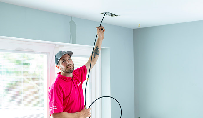 An Employee is Doing Air Duct Sanitization