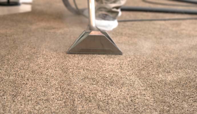 Carpet cleaning extraction wand removing deep dirt and odors from carpet