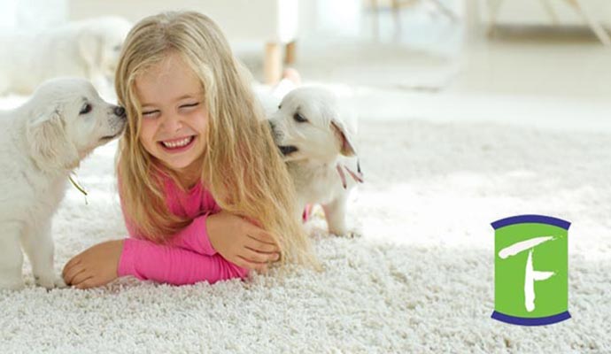 kid with pets on carpet