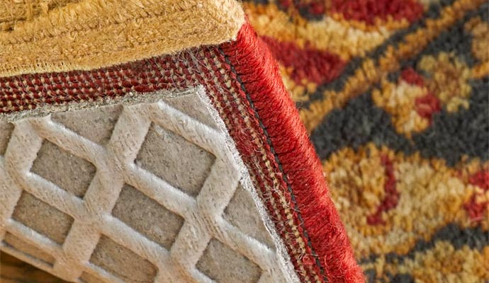 Close-up of moisture barrier rug pad backing under rug