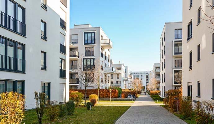Multi-tenant apartment complex with paved walkways and landscaping