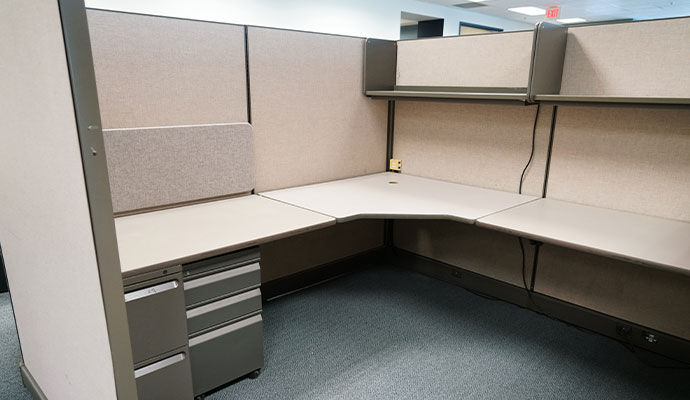 Clean office cubicle with beige panels and a clean workspace setup