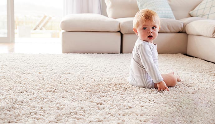 Cute baby on eco friendly cleaned carpet