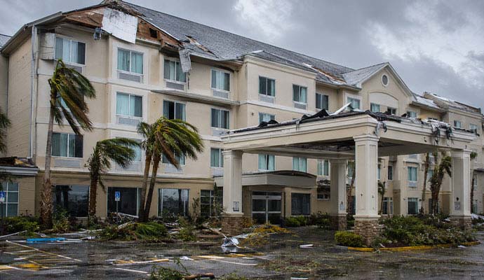 Exterior view of a multi-story hotel damaged by a severe storm