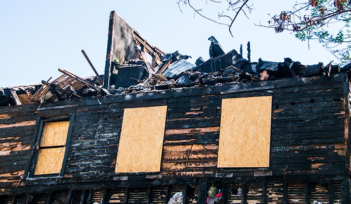 board-up in a charred a house