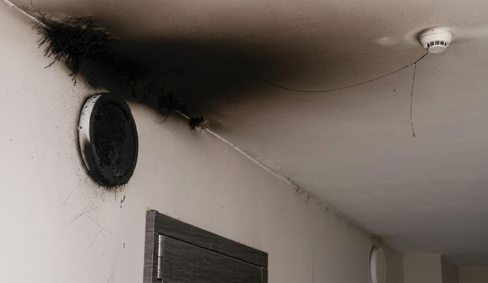 Heavy black soot and smoke damage on a wall