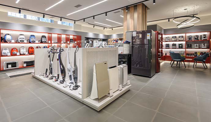 Interior view of a modern home appliance store with clean tile floor