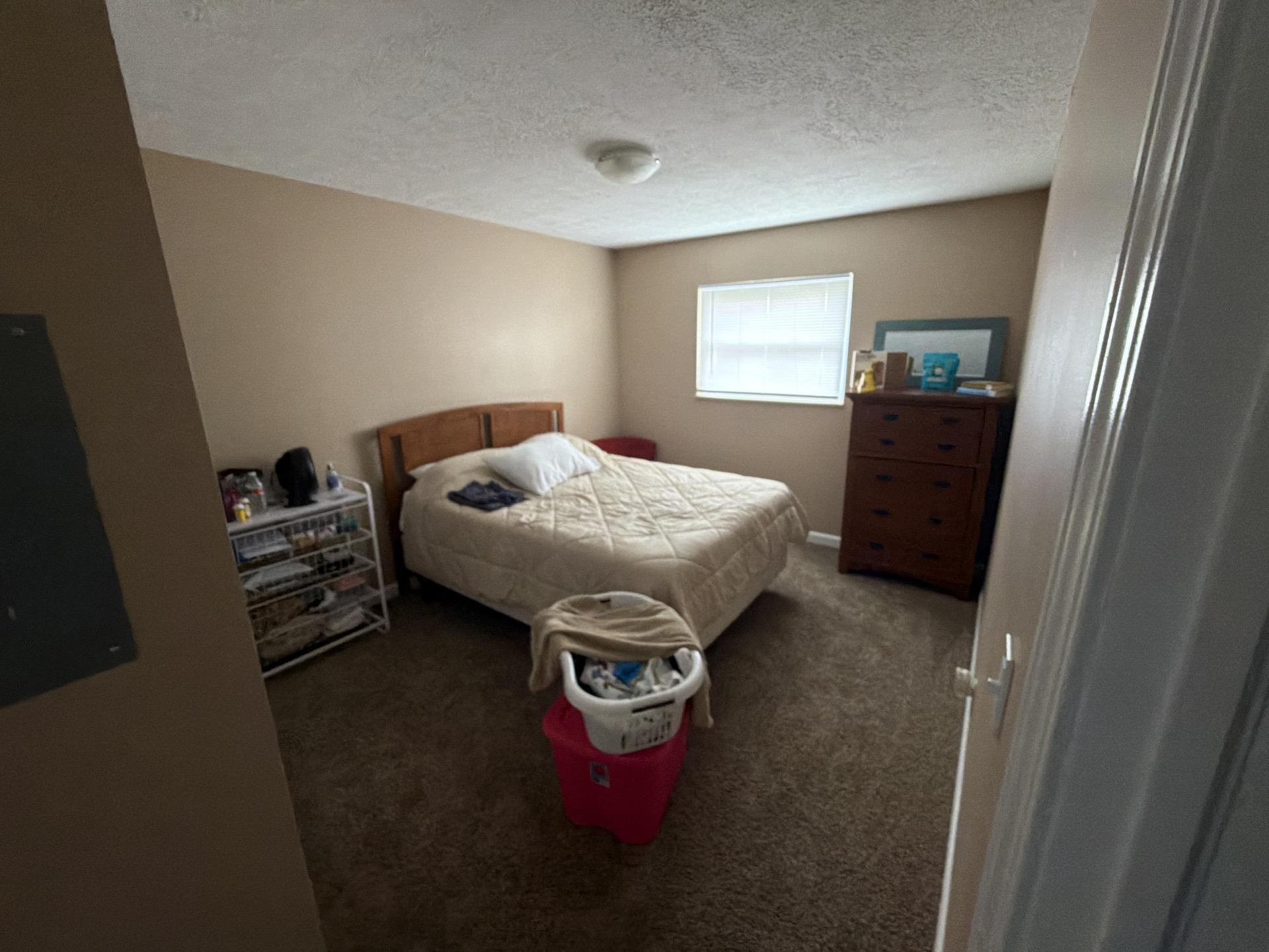 Fully restored residential bedroom with clean carpeting following professional indoor water damage mitigation.