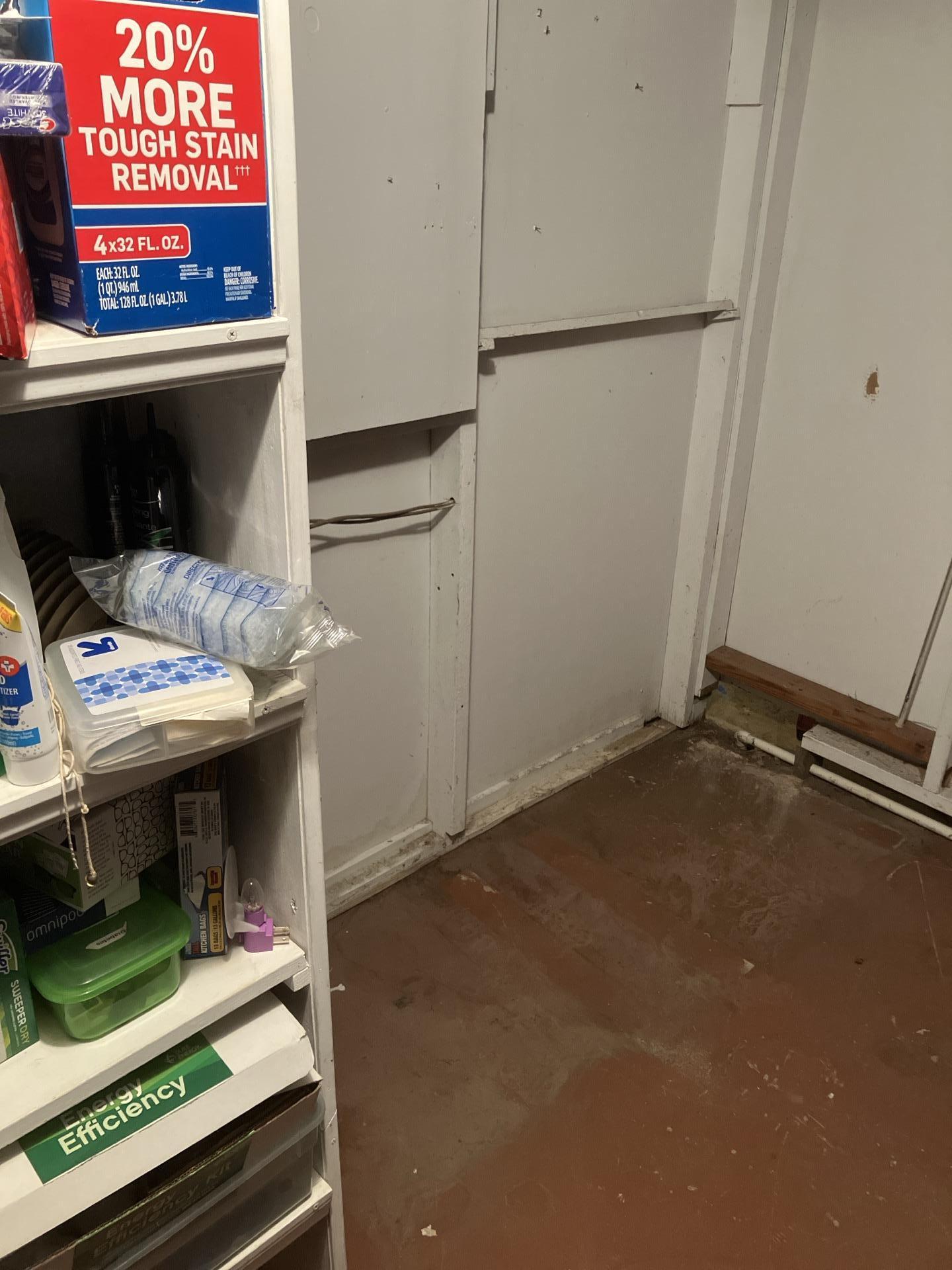 Basement area after initial water damage cleanup by Teasdale Fenton Restoration, showing concrete floor and clear space ready for drying.