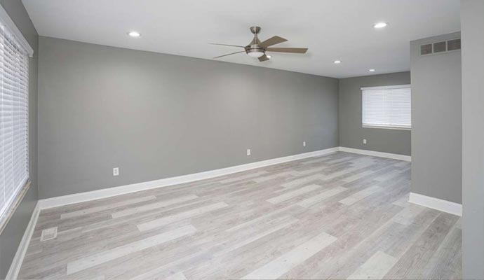 Cleaning a laminate floor by a worker.