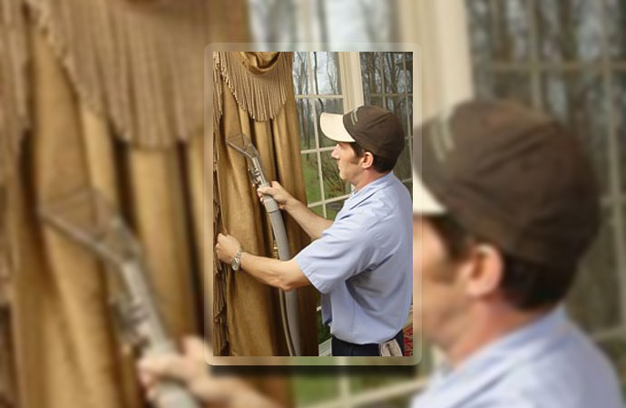 Professional worker cleaning drapery in Cincinnati & Dayton, OH