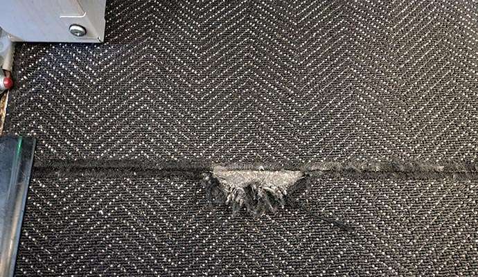 Ripped carpet repair service