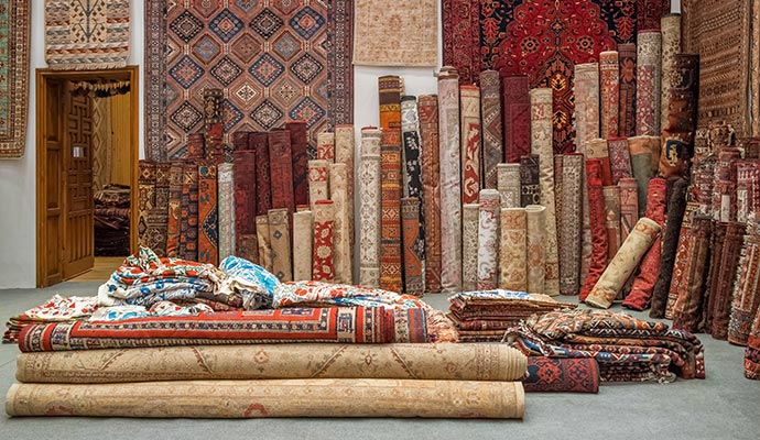 Rolled and folded oriental rugs in storage facility
