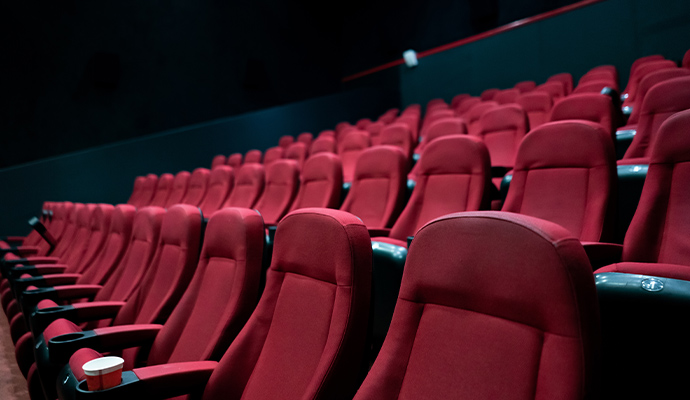 Rows of red fabric upholstered movie theater seats