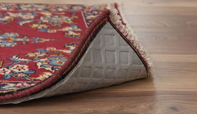 Rug with rug pad on wooden floor