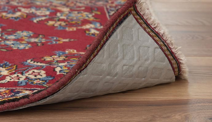 Rug with rug pad on wooden floor
