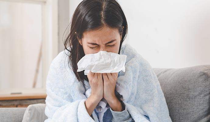 Person sneezing due to allergy