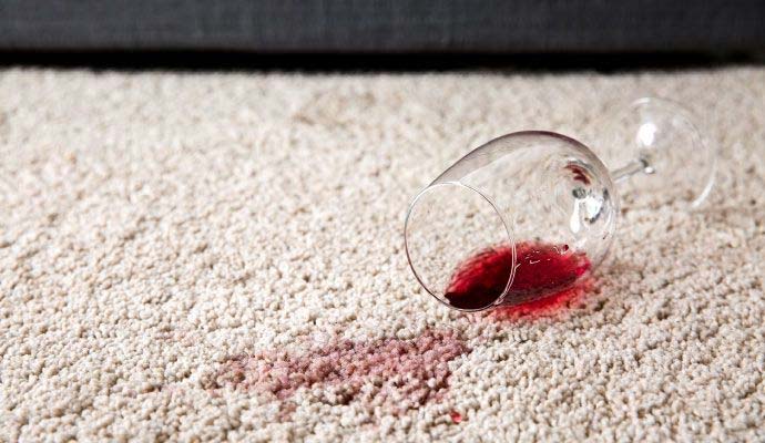 Red wine spilled on beige carpet
