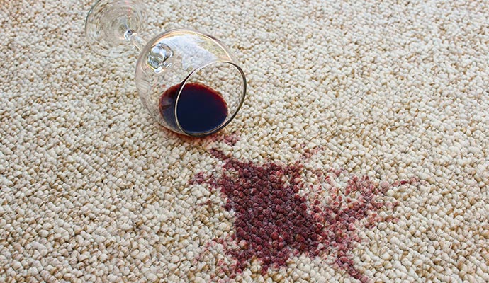 Spilled red wine glass on beige carpet