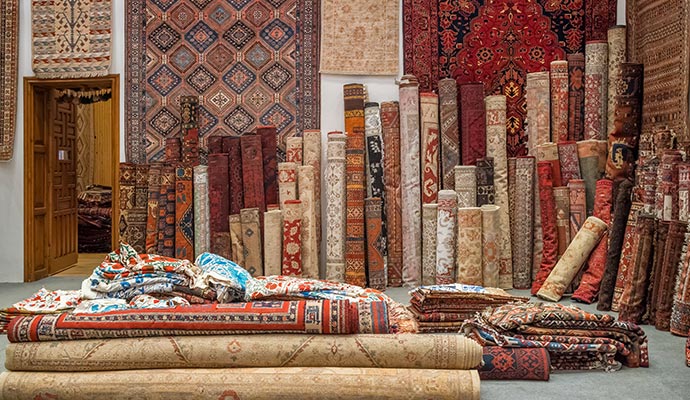 A few rolled rugs stored in a rug storage facility