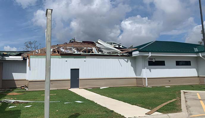 Storm damaged building roof collapse