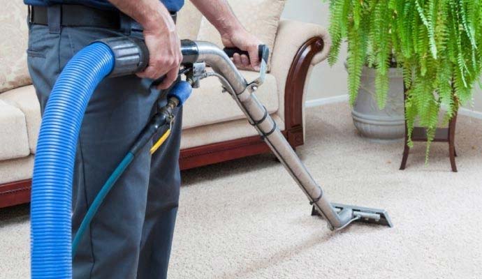 Tech nician cleaning carpet with machine