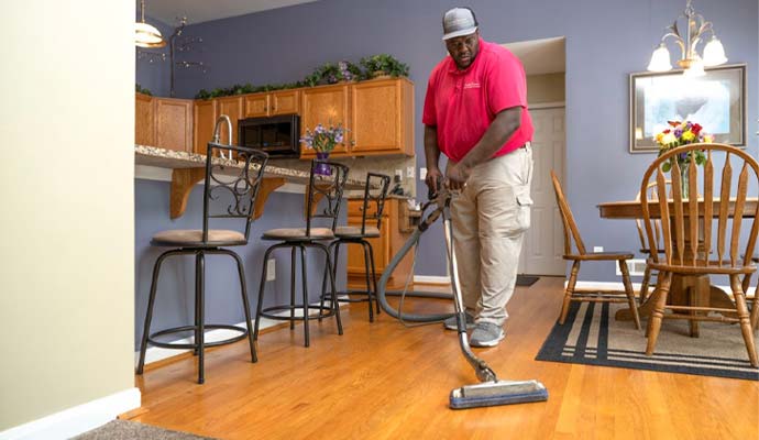 Professional technician deep cleaning hardwood floors