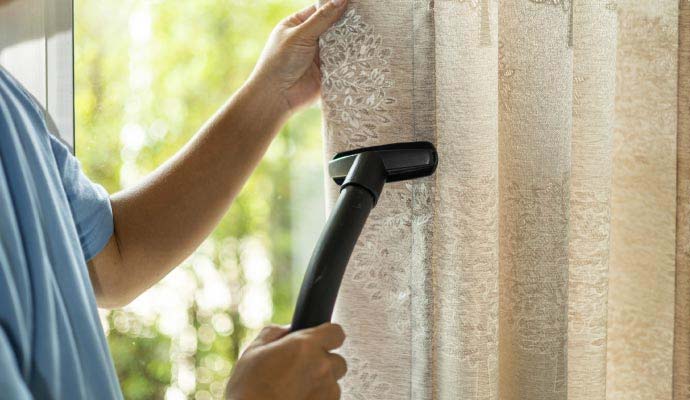 Professional cleaning of window draperies