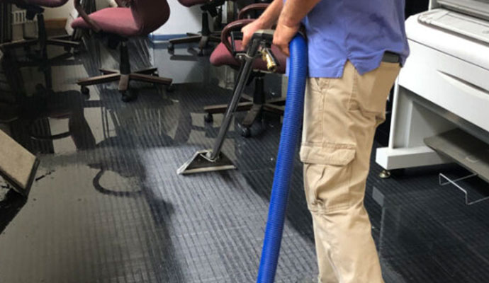 Worker restoring water-damaged carpet in Cincinnati
