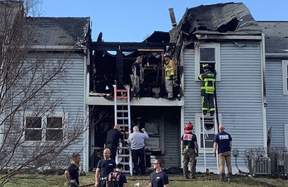 professionals cleaning up a fire damaged house