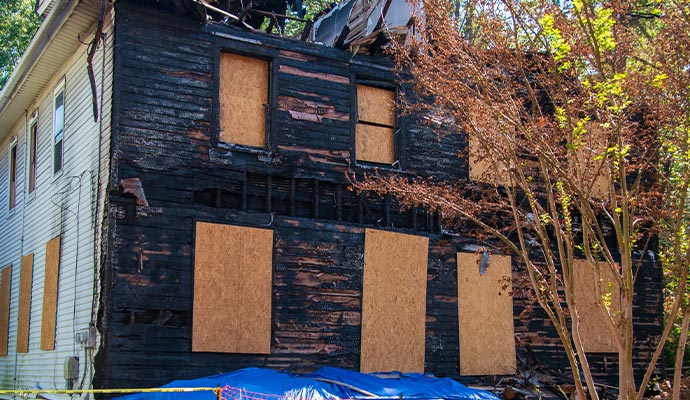 Board-up fire damaged house